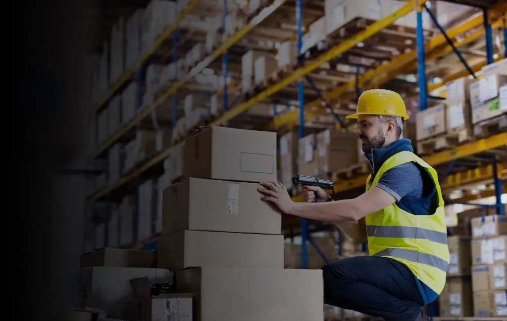 Automated conveyor system moving e-commerce order boxes through a fulfillment center
