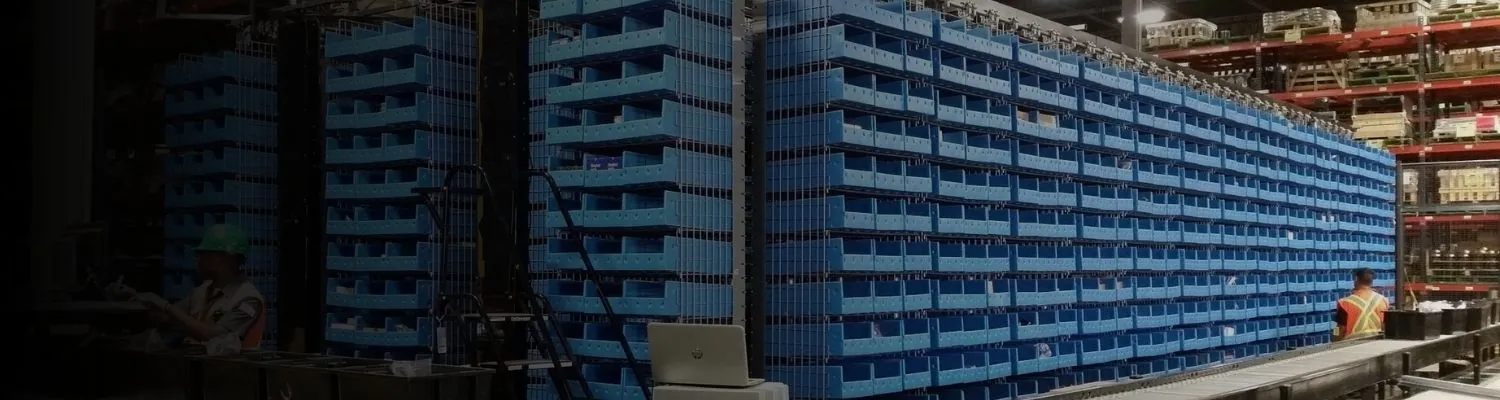 Horizontal carousel storage system rotating shelving to deliver bins to a picking operator
