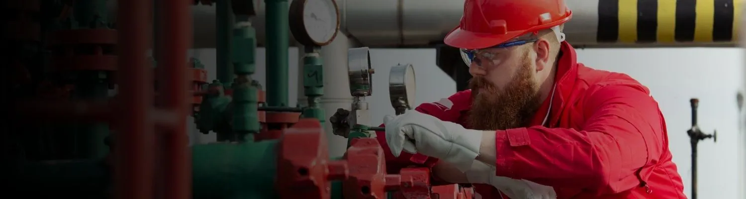 Oil and gas refinery pipelines and processing towers at an industrial site